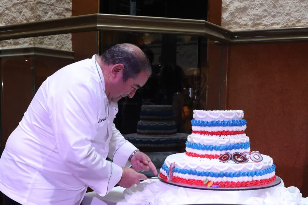 carnival cruise line emeril lagasse cutting cake