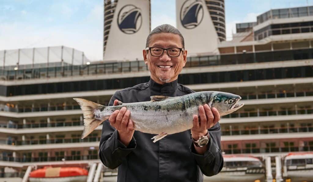 chef morimoto holding a fish holland america
